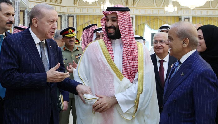 Turkish President Tayyip Erdogan, Saudi Crown Prince Mohammed bin Salman and Pakistans Prime Minister Shehbaz Sharif chat after signing a joint defense agreement in Mekkah, Saudi Arabia, August 7, 2026. — Reuters