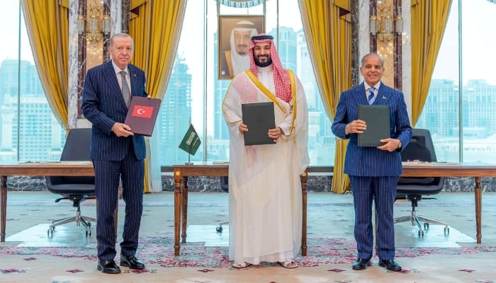 Turkish President Tayyip Erdogan, Saudi Crown Prince Mohammed bin Salman, and Prime Minister Shehbaz Sharif pose after signing the joint defence agreement in Makkah, Saudi Arabia, August 7, 2026. — Reuters