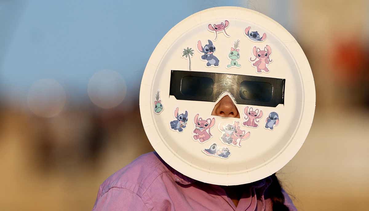 A girl observes the total solar eclipse as seen from the sea port of Tarragona, east of Spain,, on August 12, 2026.— AFP