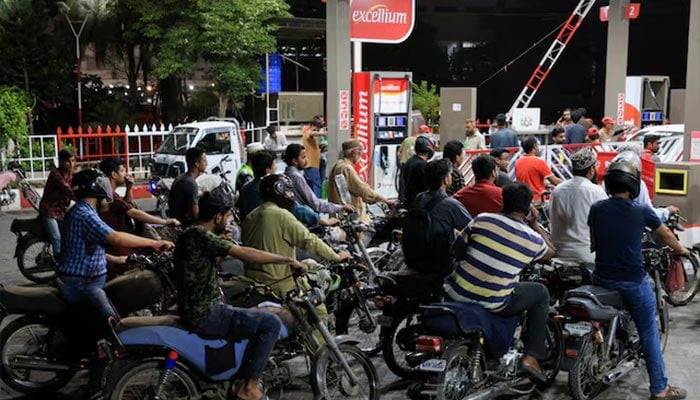 People wait for their turn to get fuel at a petrol station in Karachi, July 4, 2024. — Reuters