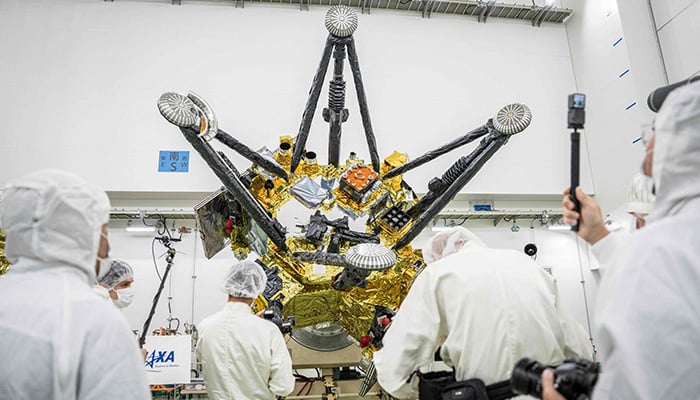 Members of the media film Exploration and Return Modules, making up the Martian Moons eXploration (MMX) spacecraft, at the Tanegashima Space Center in Minamitane, Kagoshima prefecture on August 13, 2026. — AFP