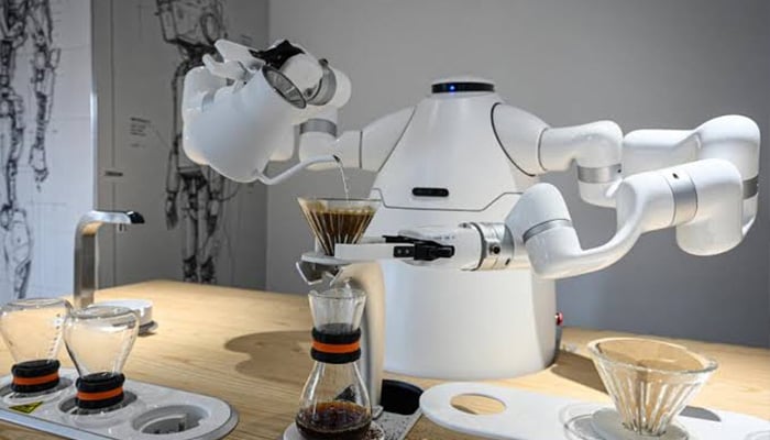 A robot manufactured by Zhejiang University Robot Research Institute making making coffee at the Hangzhou Robot school in Hangzhou, in eastern Chinas Zhejiang province. — AFP