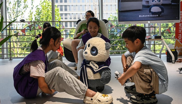 Children playing with robot named Pangda at the Hangzhou Robot school in Hangzhou, in eastern Chinas Zhejiang province. — AFP