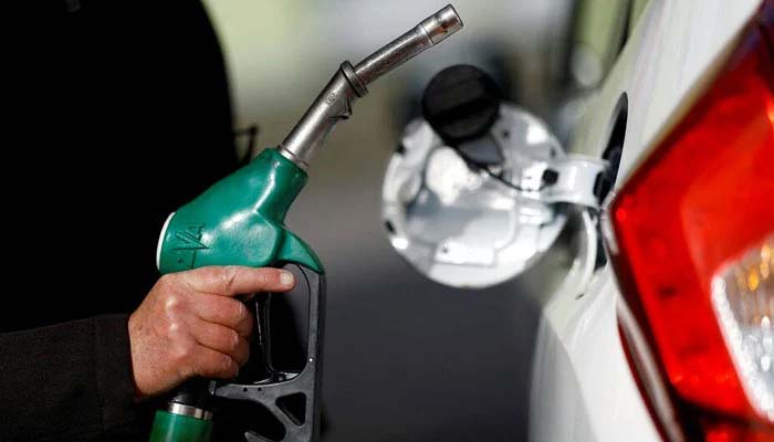 A man holds a fuel nozzle at a petrol station in Reze, near Nantes, France, March 18, 2022. — Reuters