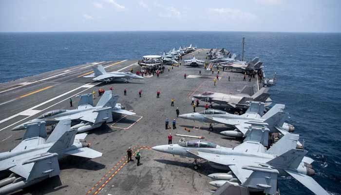US Navy sailors work on the flight deck of the aircraft carrier USS George Washington as it transits the Arabian Sea to support US military operations in the war with Iran August 20, 2026. — Reuters