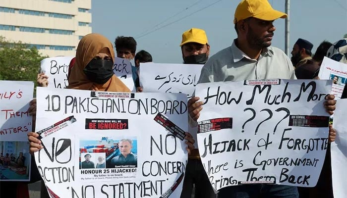 Families of the Pakistani hostage crew members of the Oil Products Tanker the HONOUR 25 that was hijacked by pirates off the coast of Somalia, hold placards during a protest in Karachi, May 13, 2026. — Reuters