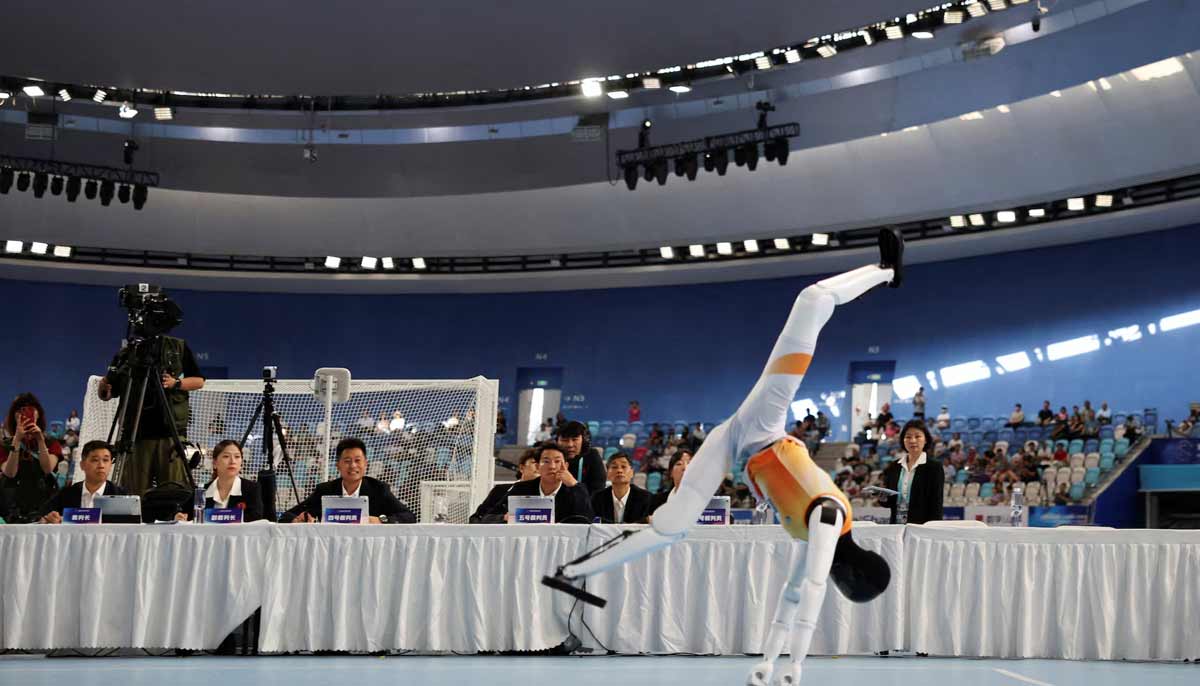 Judges watch a humanoid robot perform at the gymnastics floor exercise competition, during the second World Humanoid Robot Games at the National Speed Skating Oval in Beijing, China August 24.— Reuters