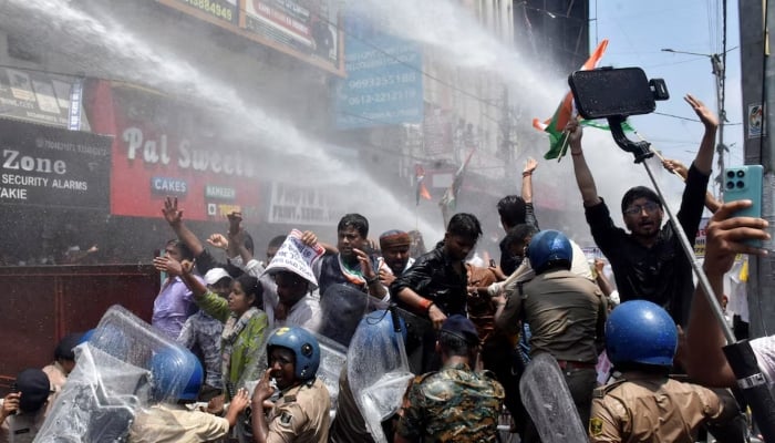 Students gesture as police use water cannons to disperse them, during a protest demanding cancellation of a civil services recruitment examination over allegations of question paper leaks and other irregularities, in Patna, India, August 25, 2026. — Reuters