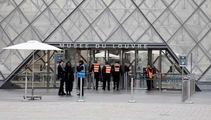 Security employees enter the glass Pyramid of the Louvre Museum as the museum remains closed the day after a spectacular jewel heist by thieves who broke into the landmark by using a crane and smashing an upstairs window, stealing priceless jewelry from an area that houses the French crown jewels before escaping on motorbikes, in Paris, France, October 20, 2025.— Reuters