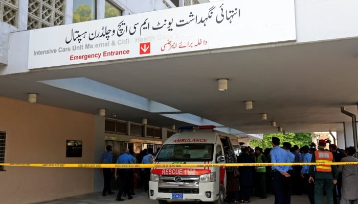 Police officers move past an ambulance outside an intensive care unit after a fire broke out at the Pakistan Institute of Medical Sciences (Pims) hospital in Islamabad, August 26, 2026. — Reuters