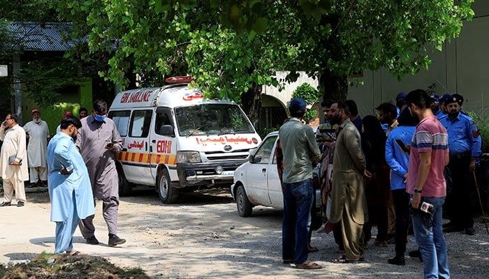 Family members and police officers stand outside a mortuary following a deadly fire at the Pakistan Institute of Medical Sciences (Pims) hospital in Islamabad, August 26, 2026. — Reuters
