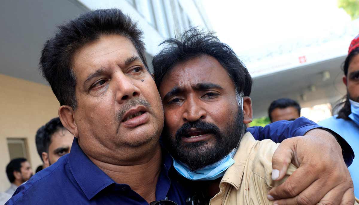Samiullah, father of a newborn victim, is consoled following a deadly fire at the Pakistan Institute of Medical Sciences hospital in Islamabad, August 26, 2026.— Reuters