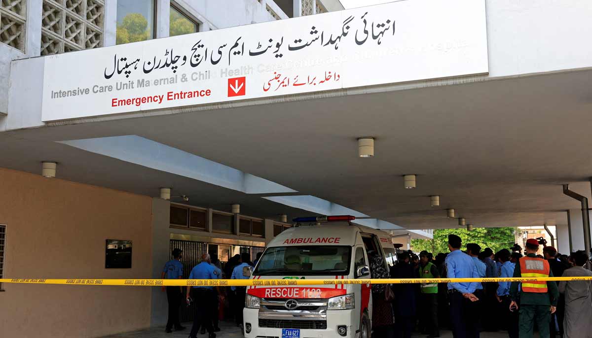 Police officers move past an ambulance outside an intensive care unit after a fire broke out at the Pakistan Institute of Medical Sciences hospital in Islamabad, August 26, 2026.— Reuters