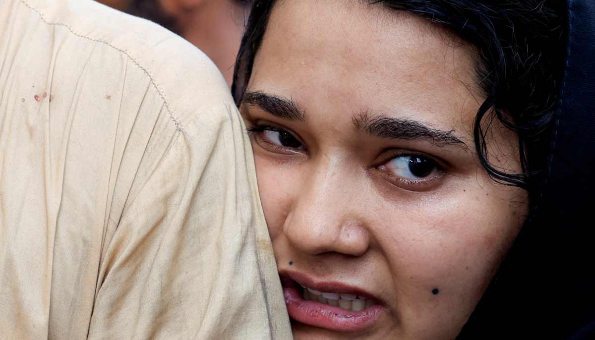 Javeria, mother of a newborn victim, leans on her husband’s shoulder as she mourns following a deadly fire at the Pakistan Institute of Medical Sciences hospital in Islamabad, August 26, 2026.— Reuters
