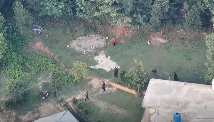 Armed members belonging to the banned Jammu Kashmir Joint Awami Action Committee (JAAC) attack security forces in Rawalakot, Azad Jammu and Kashmir. — Screengrab via Facebook/@ajkpolice