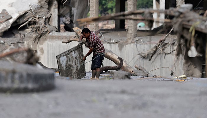 A man salvages his belongings from mud following devastating floods, in Trishuli, Nuwakot district, Nepal, August 27, 2026. — Reuters