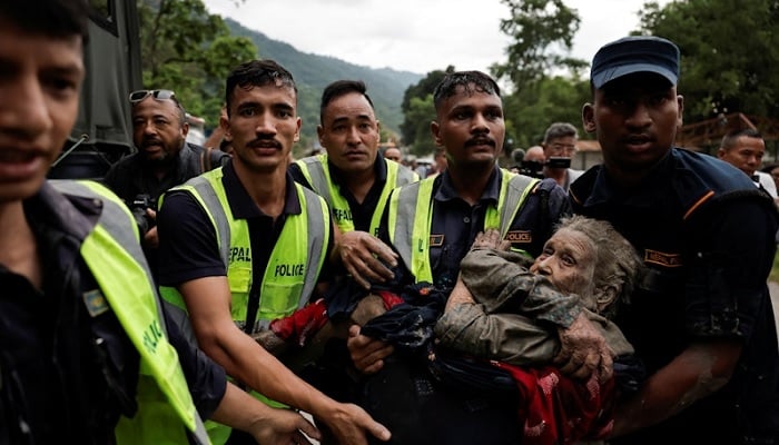 Police officers carry a survivor in Nuwakot district, Nepal, August 26, 2026. — Reuters