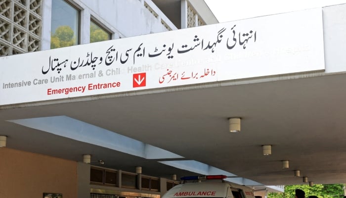 Police officers move past an ambulance outside an intensive care unit after a fire broke out at the Pakistan Institute of Medical Sciences (Pims) hospital in Islamabad, August 26, 2026. — Reuters