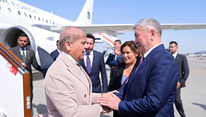 Chairman of the Cabinet of Ministers of Kyrgyzstan Adylbek Kasymaliev (right) welcomes Prime Minister Shehbaz Sharif upon his arrival at the Manas International Airport in Bishkek, August 31, 2026. — X/PakPMO