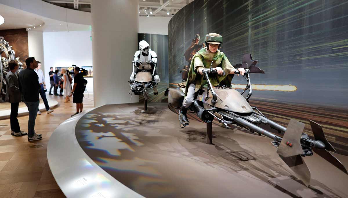An Imperial speeder bike (R) from Return of the Jedi is displayed at the new Lucas Museum of Narrative Art during a media preview of the 300,000 square foot structure in Exposition Park on September 2, 2026 in Los Angeles, California.— AFP