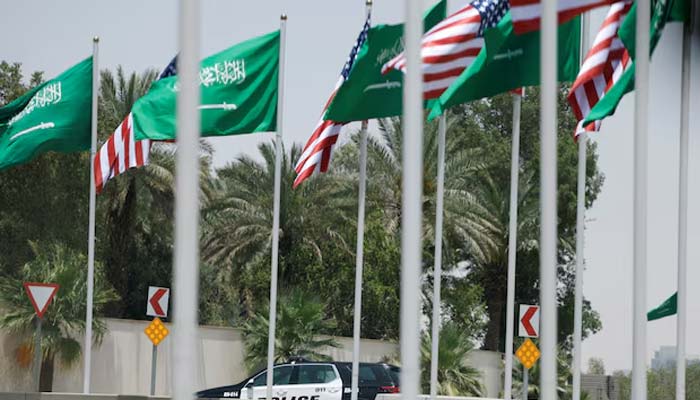 US and Saudi flags flutter along a highway of Riyadh, as pictured through the glass of a car, ahead of the arrival of US President Donald Trump in Riyadh, Saudi Arabia, on May 12, 2025. — Reuters