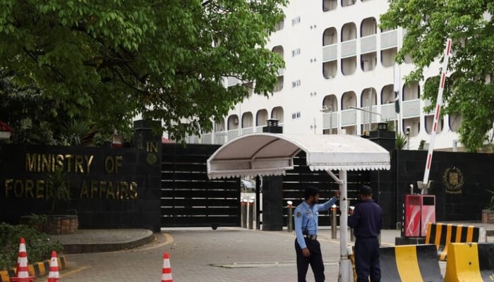 A police officer and a security guard stand outside the Ministry of Foreign Affairs office in Islamabad, March 28, 2026. — Reuters