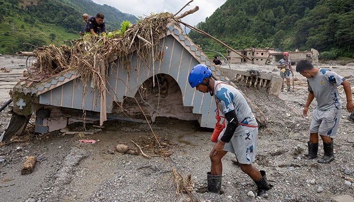 Nepal Police and Armed Police Force (APF) members search the house of Chandika Kumari Shrestha, who was rescued alive on Saturday, for more survivors and victims of the deadly flash floods and mudslides, in Betrawati, Nuwakot district, Nepal, September 6, 2026. — Reuters