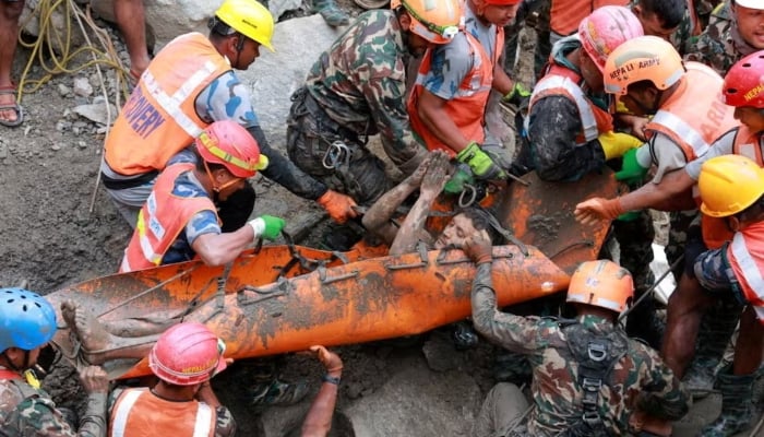 Survivor Kabir Maharjan is carried by members of a search and rescue team after they rescued two people alive who had been trapped inside a tunnel at the Trishuli-3A Hydropower Project following devastating floods and mudslides that struck the Bhotekoshi River in Rasuwa, Nepal, September 4, 2026. — Reuters