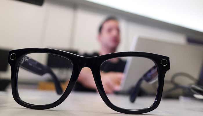 A Meta smart glass sits in front of Mark Morad, 20, a visually impaired Egyptian student, entrepreneur and developer of the AI-powered Scribeme application, as he works on his laptop while using the Scribeme application in a computer lab at the American University in Cairo (AUC) in Cairo, Egypt, August 12, 2026.— Reuters