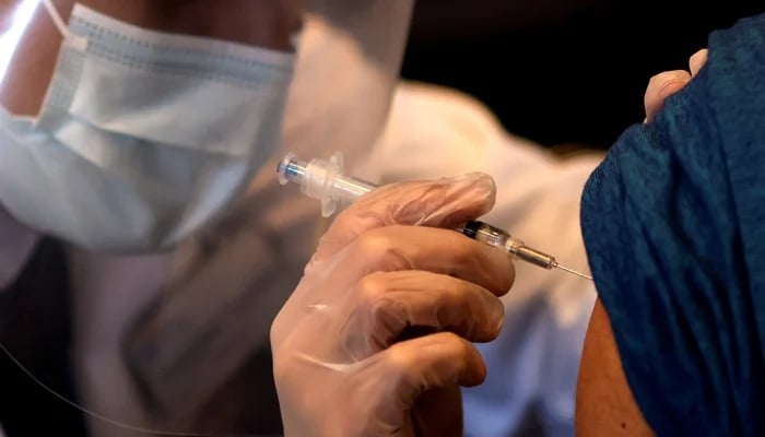 A person receives a dose of Covid-19 vaccine at a vaccination center in Chinatown, in Chicago, Illinois, US. — Reuters/File