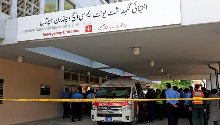 Police officers move past an ambulance outside an intensive care unit after a fire broke out at the Pakistan Institute of Medical Sciences (PIMS) hospital in Islamabad, August 26, 2026. — Reuters
